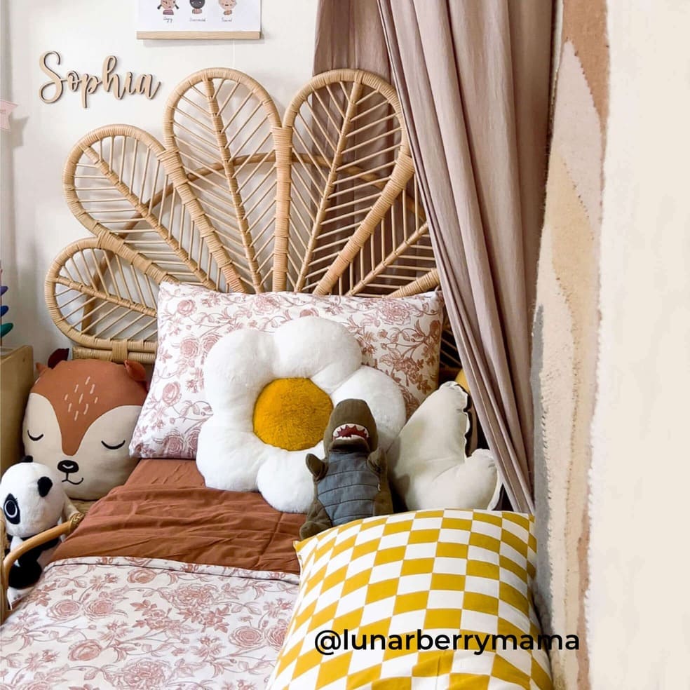 Petal Headboard by MOMIJI installed on a child’s bed, styled with plush toys, featuring the full rattan petal silhouette.