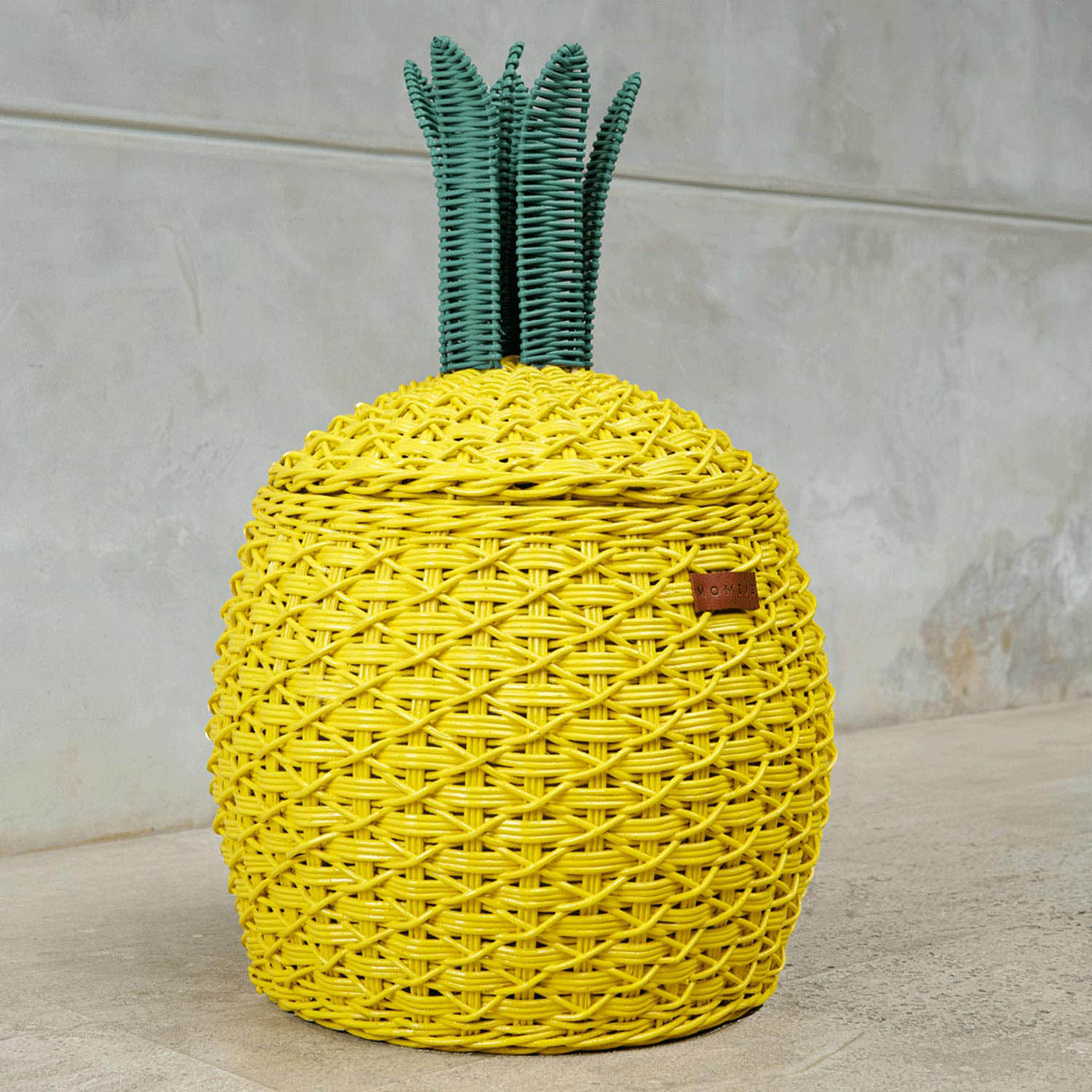 Close up side view of the yellow Pineapple Rattan Storage Basket in medium size by MOMIJI.