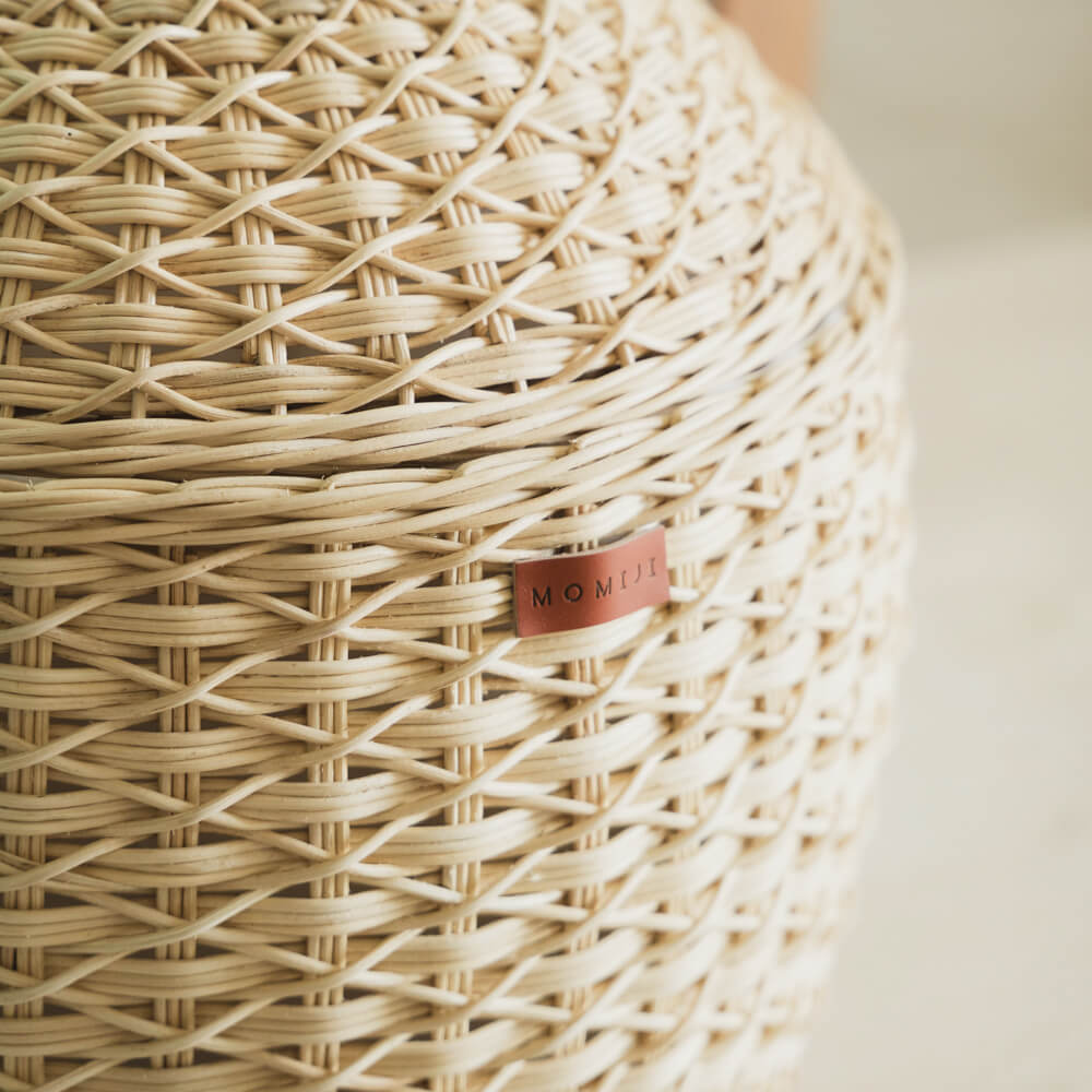 Close up MOMIJI logo on Pineapple Rattan Storage Basket in a natural color.