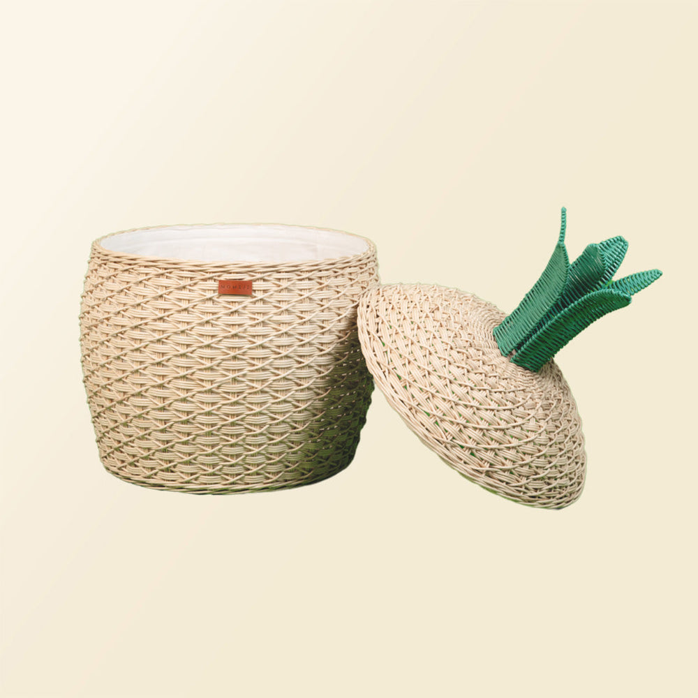 Opened Pineapple Rattan Storage Basket by MOMIJI with lid leaning beside the rattan basket.