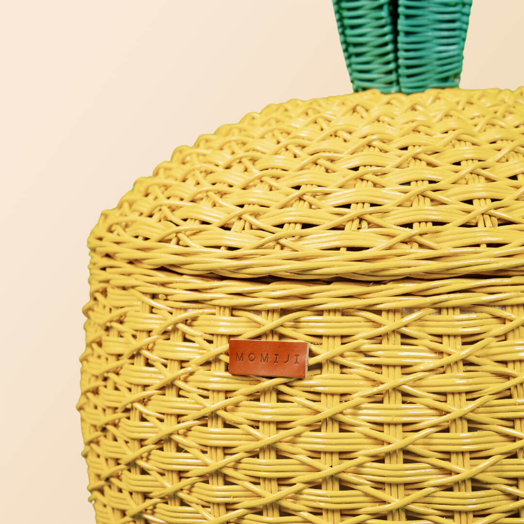 Front view of the yellow Pineapple Rattan Storage Basket in large size.