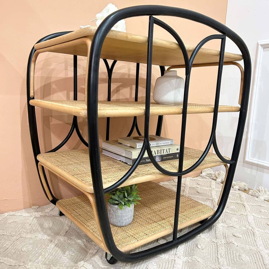Angled close-up view of the Posy Bar Cart by MOMIJI featuring a black frame and four woven rattan shelves, highlighting its woven shelf design.