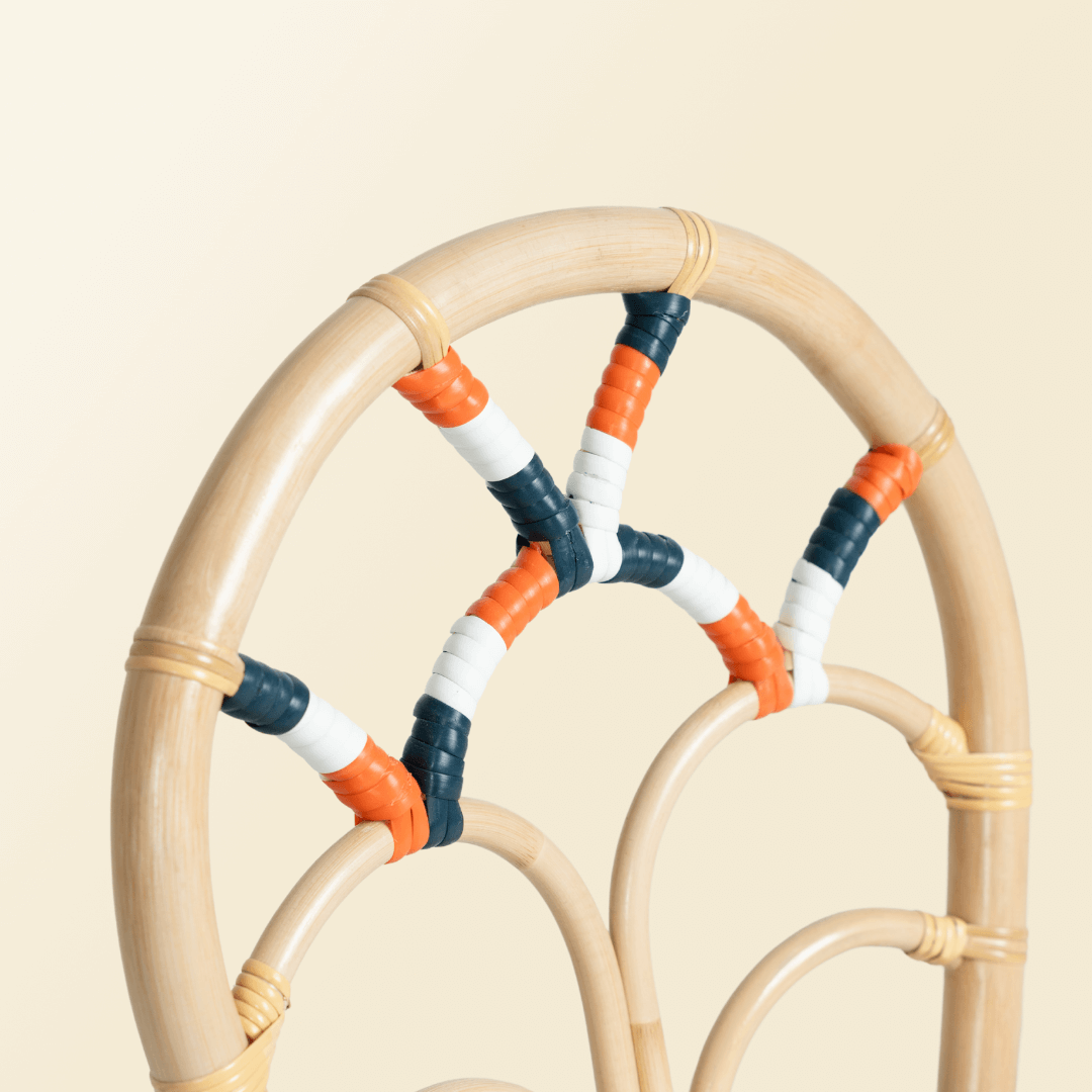 Close up view of colorful carvings on the backrest of the chair of the Quentin Chair by MOMIJI.