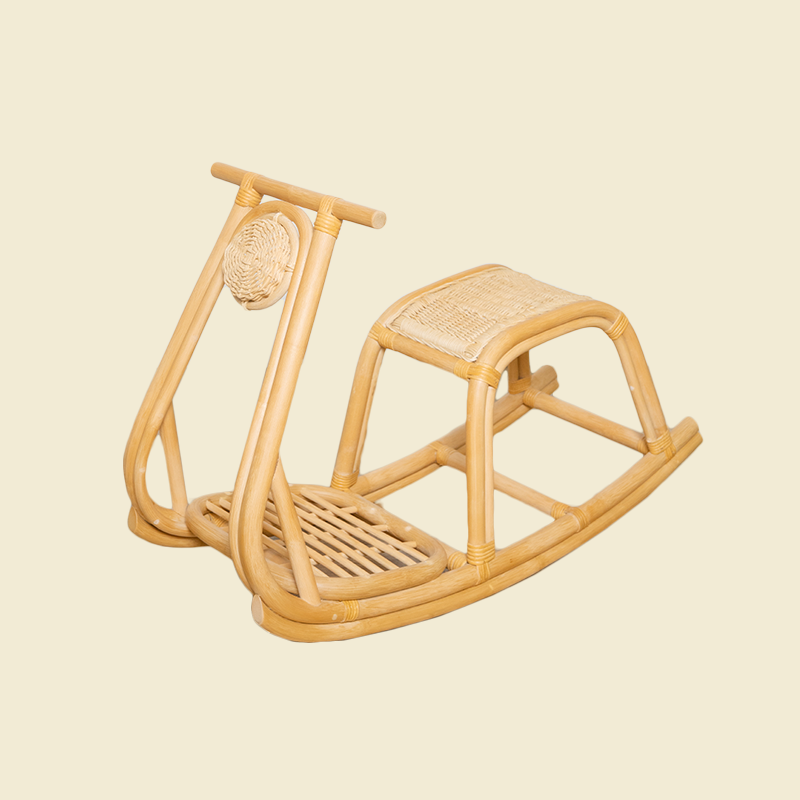 Angled view of the handcrafted rattan wicker Vespa Rocker by MOMIJI in natural, showing its complete structure including the seat, footrest, and round woven light in natural rattan

