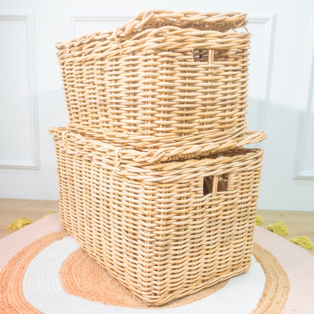 Angled view of stacked handcrafted Wicker Storage Trunks by MOMIJI displayed on a rug.