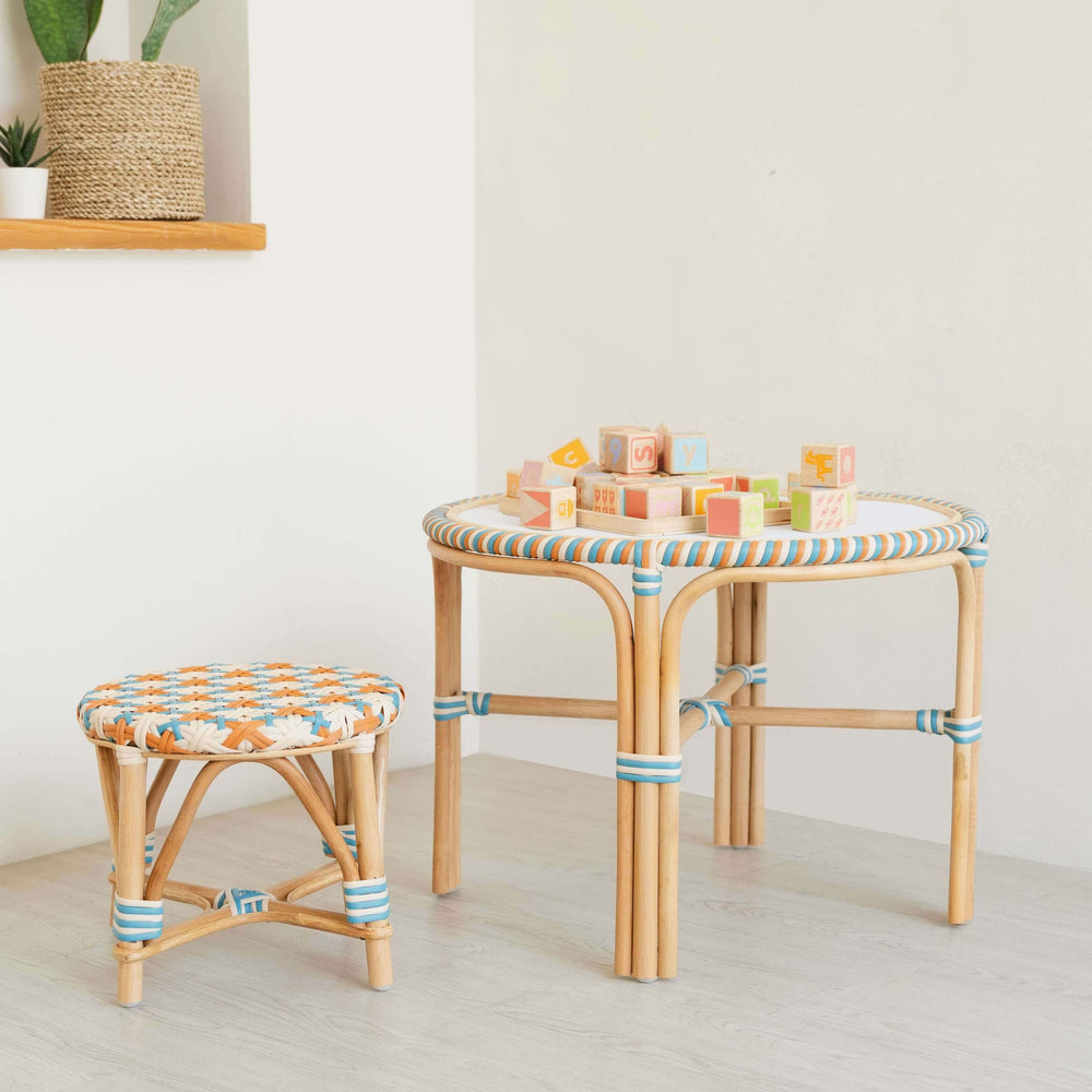 Xander Kids Table by MOMIJI and stools with colorful woven tops in a play room.