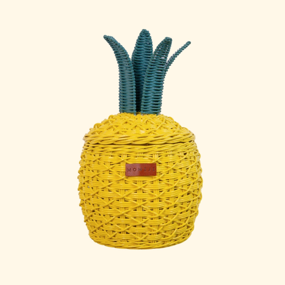 Front view of a handcrafted yellow pineapple rattan storage basket in small size, showing the woven design, MOMIJI label, and green crown lid.