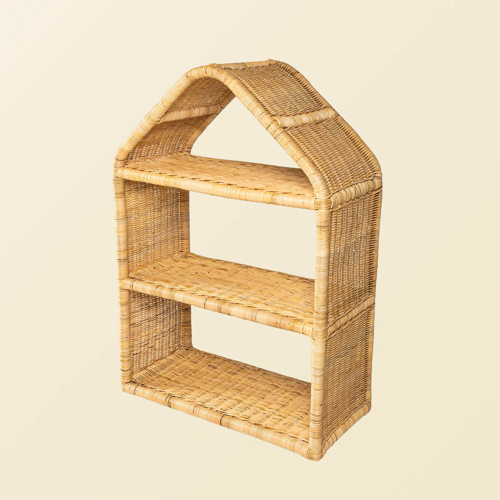 Angled view of the handcrafted Alaya house shelf by MOMIJI made from rattan wicker in beige natural rattan, showing the fully woven three-tier.