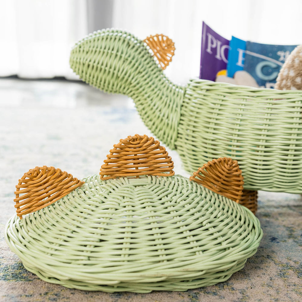 Close-up of lid of the medium size handcrafted dinosaur storage basket by MOMIJI in mint green rattan, highlighting the neat and tightly woven wicker texture with natural rattan spine detailing for durability.