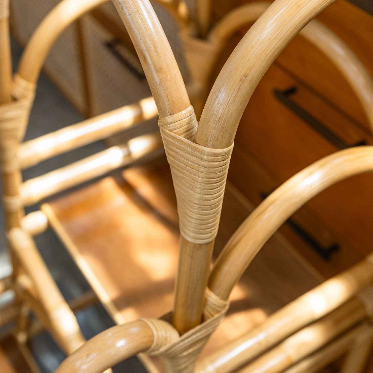 Close-up detail of the wrapped joints on a handcrafted Leon Montessori learning tower by MOMIJI with rattan wicker construction. 
