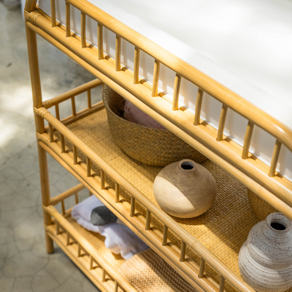 Close-up of the handcrafted rattan wicker Lestari changing table with shelves by MOMIJI, showing wicker rattan shelf bases, side rattan details.