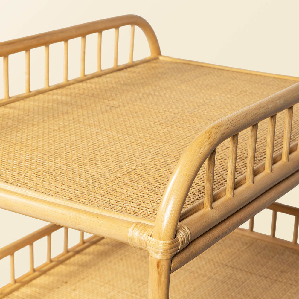 Close-up of the top surface of the handcrafted rattan wicker Lestari changing table with shelves by MOMIJI, showing the tightly rattan wacker construction used for the changing area.