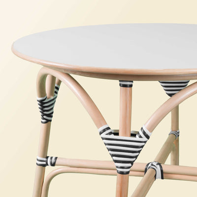 Close-up of the handcrafted rattan wicker Aulia Kids Table - Medium by MOMIJI, highlighting the black and white wrapped binding that secures the frame and prevents loosening.