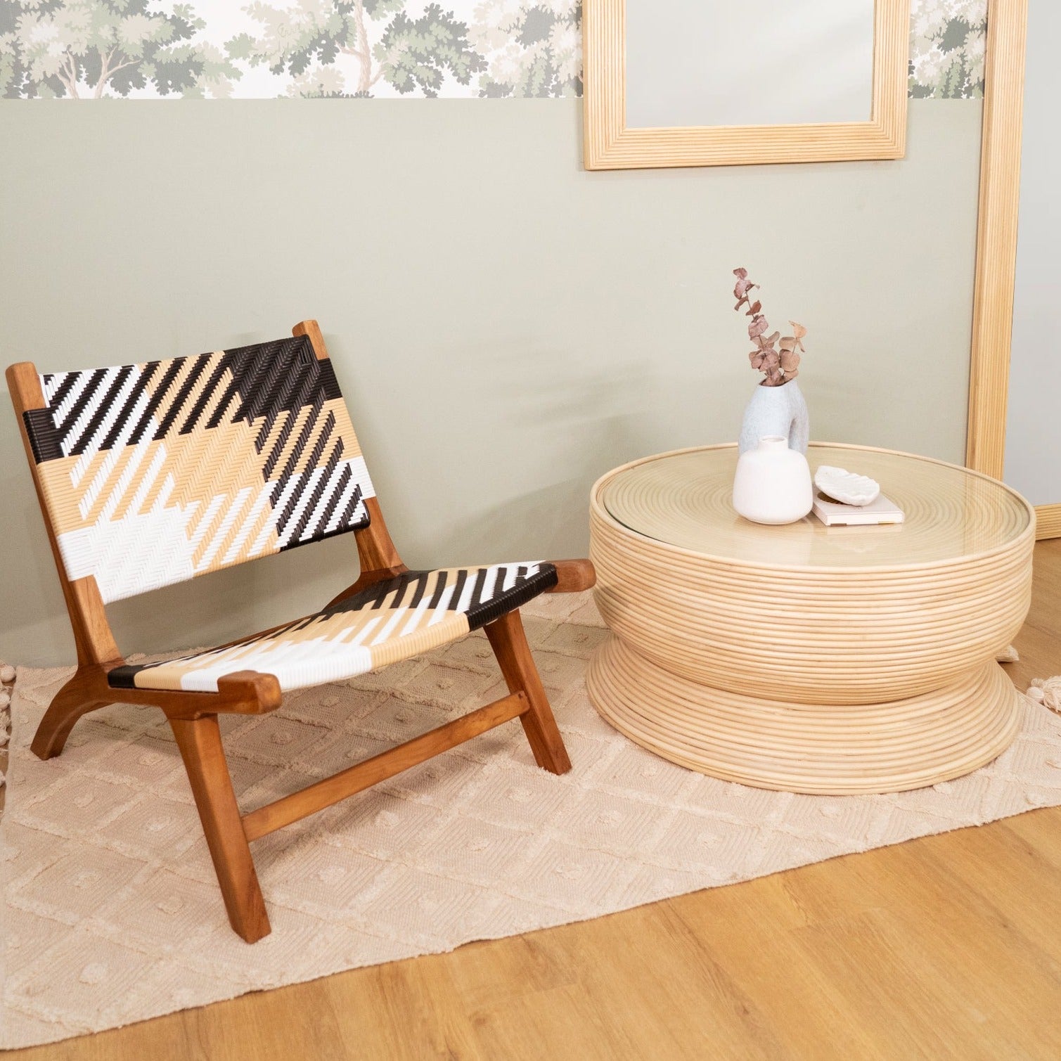 Charme Coffee Table by MOMIJI placed on a rug beside a wooden chair in an indoor setting.